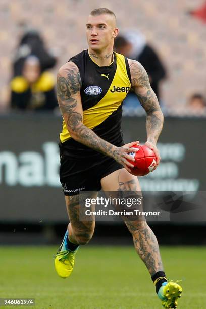 Dustin Martin of the Tigers runs with the ball during the round four AFL match between the Richmond Tigers and the Brisbane Lions at Melbourne...