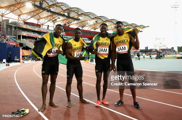 Jermaine Gayle, Demish Gaye, Jamari Rose and Javon Francis of Jamaica celebrate winning bronze in the Men's 4x400 metres relay final during athletics...