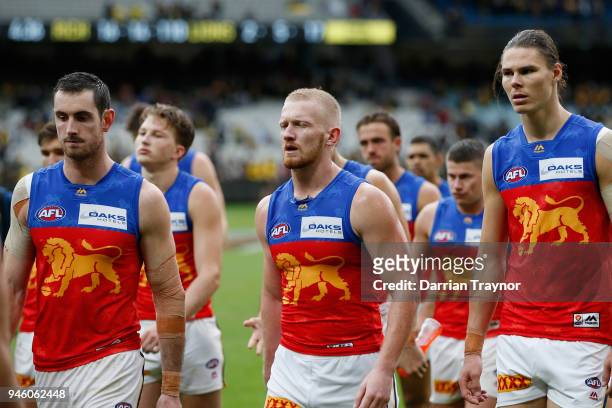 Dejected Brisbane Lions players walk off the M.C.G. After kicking just 2 goals during the round four AFL match between the Richmond Tigers and the...