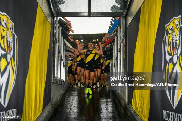 Tigers players walk into the tunnel after victory during the round four AFL match between the Richmond Tigers and the Brisbane Lions at Melbourne...