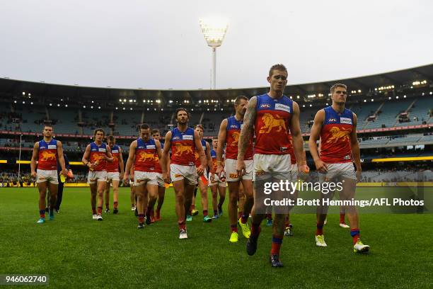 Lions players show their dejection after defeat during the round four AFL match between the Richmond Tigers and the Brisbane Lions at Melbourne...