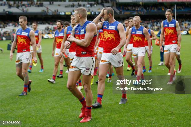 Dejected Brisbane Lions players walk off the M.C.G. After kicking just 2 goals during the round four AFL match between the Richmond Tigers and the...