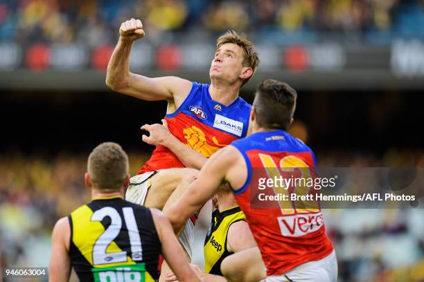 Harris Andrews of the Lions punches the ball clear during the round four AFL match between the Richmond Tigers and the Brisbane Lions at Melbourne...