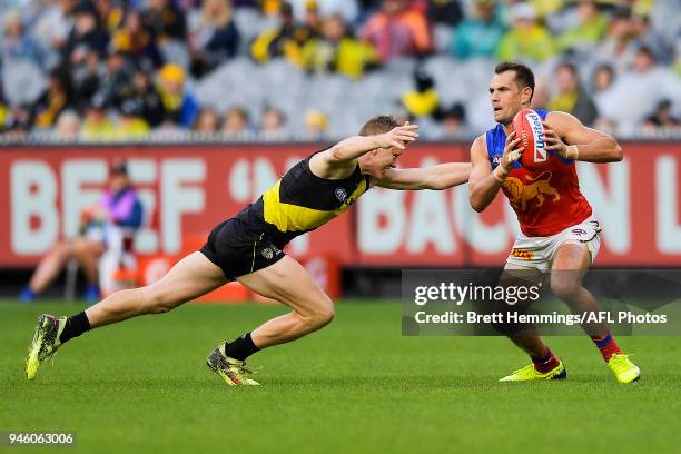 Luke Hodge of the Lions is tackled during the round four AFL match between the Richmond Tigers and the Brisbane Lions at Melbourne Cricket Ground on...
