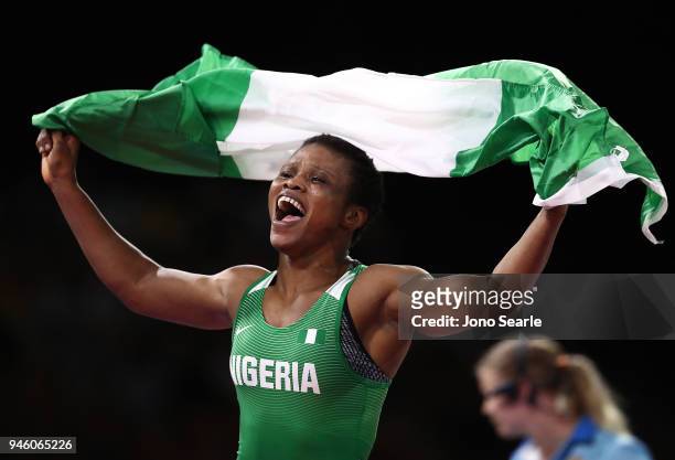 Aminat Adeniyi of Nigeria celebrates winning gold against Michelle Fazzari of Canada in the women's 62kg Nordic round during Wrestling on day 10 of...