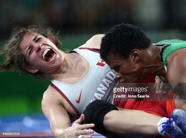 Michelle Fazzari of Canada screams in pain as Aminat Adeniyi of Nigeria wins gold in her fight in the women's 62kg Nordic round during Wrestling on...
