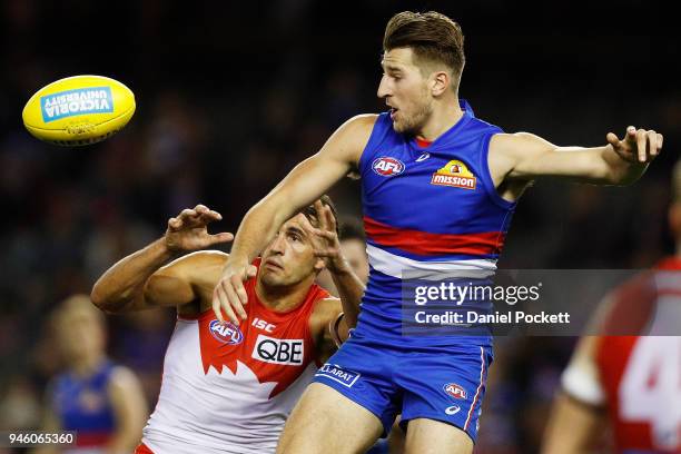 Josh P. Kennedy of the Swans and Marcus Bontempelli of the Bulldogs contest the ball during the round four AFL match between the Western Bulldogs and...