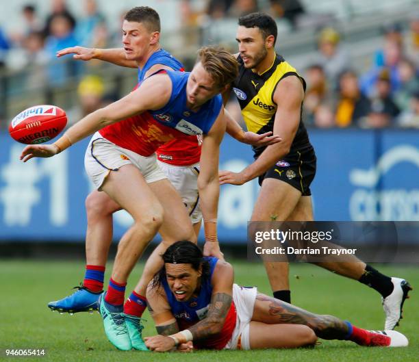 Allen Christensen of the Lions handballs during the round four AFL match between the Richmond Tigers and the Brisbane Lions at Melbourne Cricket...