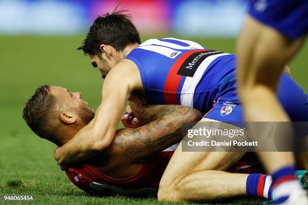 Lance Franklin of the Swans and Easton Wood of the Bulldogs wrestle during the round four AFL match between the Western Bulldogs and the Sydney Swans...