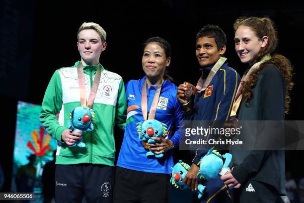 Silver medalist Kristina O'Hara of Northern Ireland, Gold medalist Mary Kom of India, Bronze medalists Tasmyn Benny of New Zealand and Anusha...