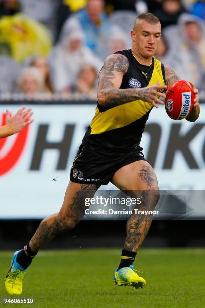 Dustin Martin of the Tigers kicks the ball during the round four AFL match between the Richmond Tigers and the Brisbane Lions at Melbourne Cricket...