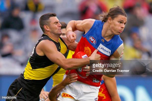 Jack Graham of the TIgers tackles Eric Hipwood of the Lions during the round four AFL match between the Richmond Tigers and the Brisbane Lions at...