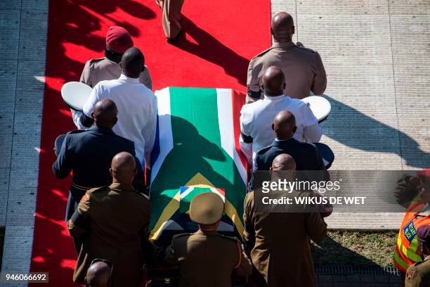 The coffin of Winnie Madikizela-Mandela is carried upon arrival at Orlando Stadium in Soweto on April 14, 2018. South Africa will lay to rest...