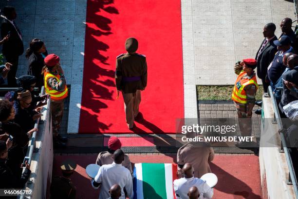 The coffin of Winnie Madikizela-Mandela is carried upon arrival for a funeral ceremony at Orlando Stadium in Soweto on April 14, 2018. South Africa...