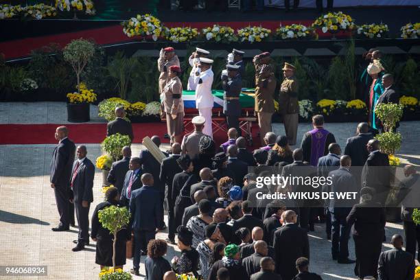 Senior military officials salute as they stand by after carrying the coffin of Winnie Madikizela-Mandela into Orlando Stadium in Soweto for a funeral...