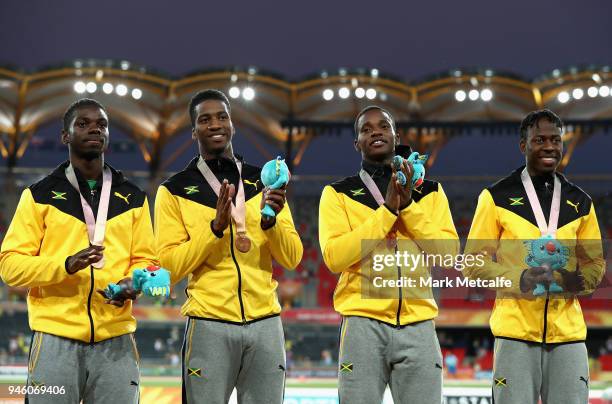 Bronze medalists Jermaine Gayle, Demish Gaye, Jamari Rose and Javon Francis of Jamaica celebrate during the medal ceremony for the Mens 4x400 metres...