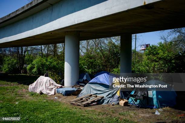 Multiple tents rest underneath an overpass in East Nashville.