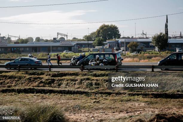 The motorcade transporting the coffin of Winnie Madikizela-Mandela drives through Soweto after leaving her home towards Orlando Stadium for a funeral...