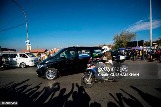 The motorcade transporting the coffin of Winnie Madikizela-Mandela drives through Soweto after leaving her home towards Orlando Stadium for a funeral...