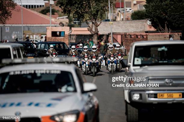 The motorcade transporting the coffin of Winnie Madikizela-Mandela drives through Soweto after leaving her home towards Orlando Stadium for a funeral...