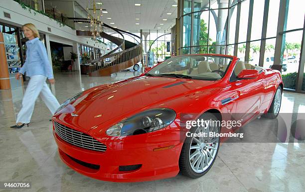 Aston Martin of Palm Beach sales associate Patricia Romeo walks past an Aston Martin DB9 Volante valued at $186,000 in West Palm Beach, Florida on...