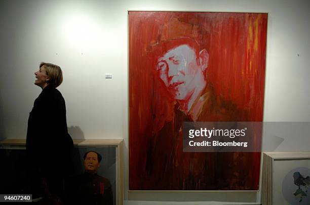Woman laughs while looking at the pieces on exhibit at the Aura Gallery during Hong Kong Art Walk, March 7 in Hong Kong, China. One night a year, the...