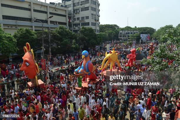 Revellers attend a rally in celebration of the Bengali New Year or 'Pohela Boishakh' in Dhaka on April 14, 2018. The Bengali calendar or Bangla...