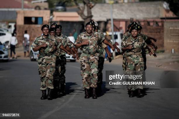 Veterans of Umkhonto we Sizwe, the military wing of the African National Congress march as they form a guard of honor ahead of the the motorcade...