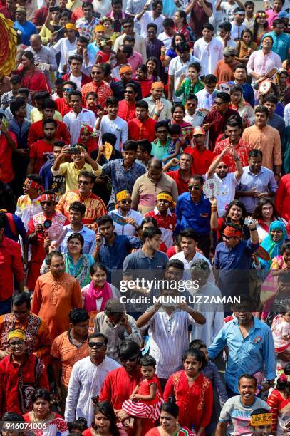 Revellers attend a rally in celebration of the Bengali New Year or 'Pohela Boishakh' in Dhaka on April 14, 2018. The Bengali calendar or Bangla...