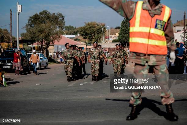 Veterans of Umkhonto we Sizwe, the military wing of the African National Congress march as they form a guard of honor ahead of the the motorcade...