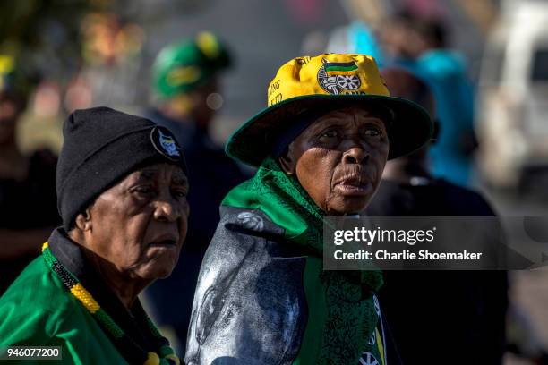 Woman line the streets near the home of Winnie Mandela to say goodbye as it makes its way to the Orlando Stadium for her funeral on in Seweto, South...