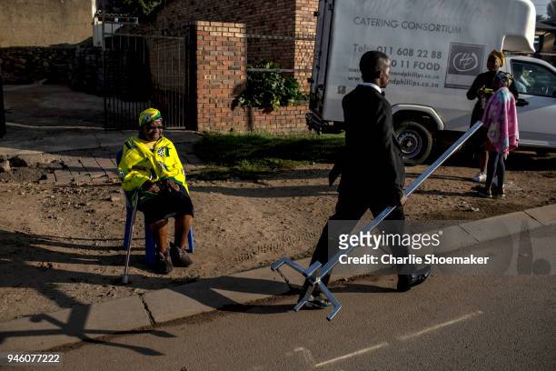 Flora Wesi who has lived on her street since 1952, waits for the body of Winnie Mandela to pass by on it's way to the funeral at the Orlando Stadium...