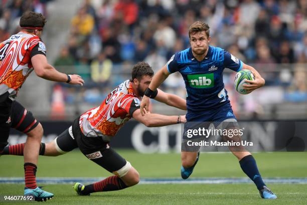 Michael Collins of Blues runs with the ball during the Super Rugby Round 9 match between the Sunwolves and the Blues at the Prince Chichibu Memorial...