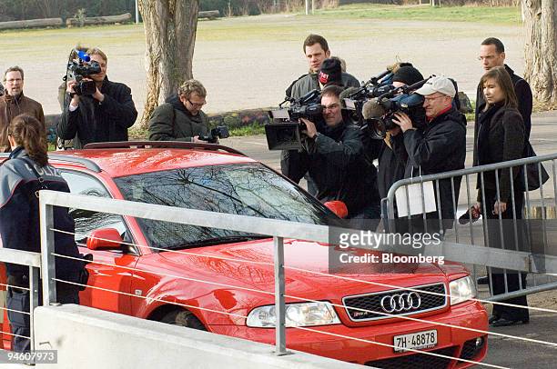 Journalists film former Swissair Board Member Eric Honegger arriving in his car for the Swissair court case in Buelach, Switzerland, Tuesday, Jan....