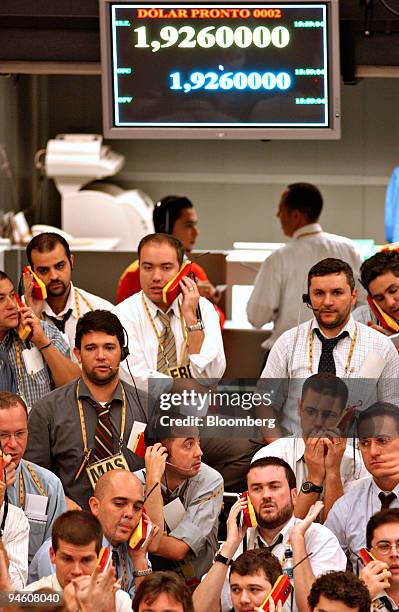 Traders work at the Brazilian Bolsa de Mercadorias e Futuros, the Brazilian Mercantile and Futures Exchange, or BM&F, in Sao Paulo, Brazil, Monday,...