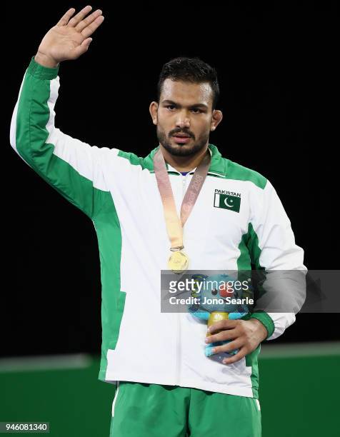Gold medalist Muhammad Inam of Pakistan poses during the medal ceremony for the men's Freestyle 86kg match during Wrestling on day 10 of the Gold...