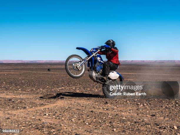 biker riding the dunes in the sahara desert - senegal landscape stock pictures, royalty-free photos & images