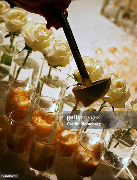 Chef pours out Peekytoe Crab Cappuccinos with Lemon Verbena at Daniel Humm's Eleven Madison Park restaurant booth at the 2007 James Beard Foundation...