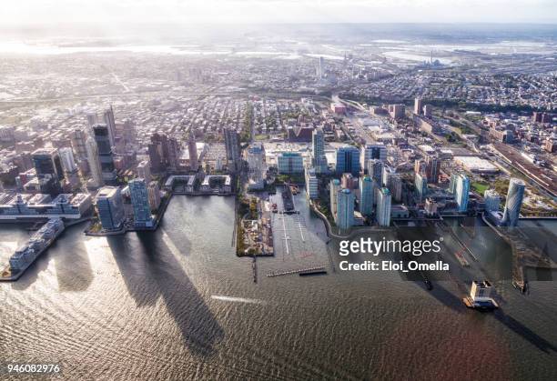 aerial view of jersey city in front of hudson river - newark new jersey imagens e fotografias de stock