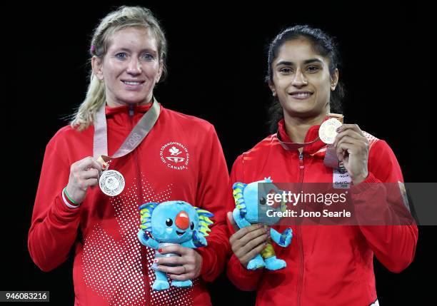 Silver Medalist Jessica MacDonald from Canada and gold medalist Vinesh Vinesh of India pose during the medal ceremony for the women's freestyle 50kg...