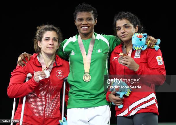 Silver Medalist Michelle Fazzari of Canada, gold medalist Aminat Adeniyi of Nigeria and bronze medalist Malik Sakshi of India pose during the medal...