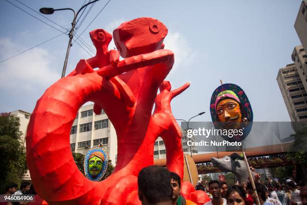 Clad in colourful attires thousands of people and students of the Faculty of Fine Arts of Dhaka University take part in the traditional Mongol...