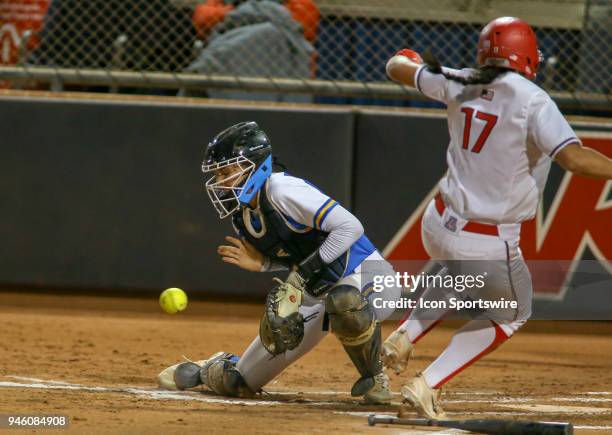 Bruins catcher Paige Halstead blocks the ball at the plate while Arizona Wildcats infielder Malia Martinez scores during a college softball game...