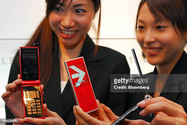 Models pose with 703i Series handsets manufactured by NTT DoCoMo Inc. At the product's launch in Tokyo, Japan, on Tuesday 16 January, 2007. NTT...