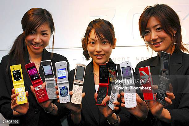 Models pose with 703i Series handsets manufactured by NTT DoCoMo Inc. At the product's launch in Tokyo, Japan, on Tuesday 16 January, 2007. NTT...