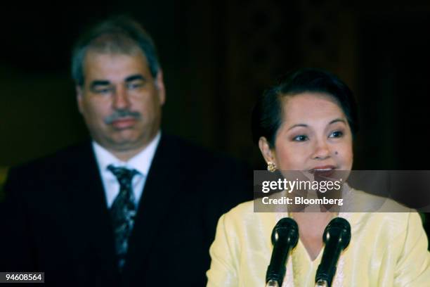 Philippine President Gloria Macapagal-Arroyo, along with Kevin Ritchie, senior vice president of Texas Instruments Inc.'s Technology and...