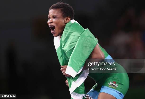 Aminat Adeniyi of Nigeria celebrates winning gold against Michelle Fazzari of Canada in the women's freestyle 62kg event during Wrestling on day 10...