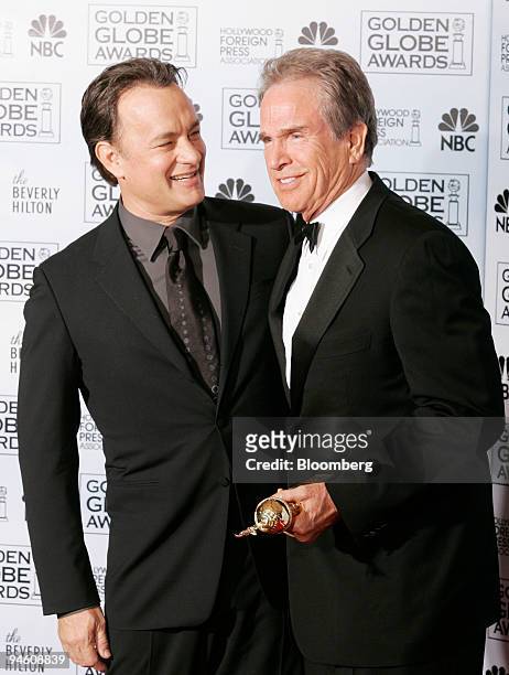 Actor Warren Beatty, right, is congratulated by actor Tom Hanks after receiving the Cecil B. DeMille Award at the Golden Globe Awards in Beverly...