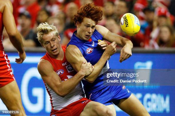 Isaac Heeney of the Swans tackles Ed Richards of the Bulldogs during the round four AFL match between the Western Bulldogs and the Sydney Swans at...