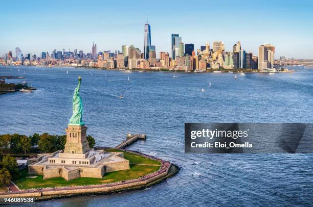 vista aérea da estátua da liberdade em frente do horizonte de manhattan. nova york. estados unidos da américa - statue of liberty new york city - fotografias e filmes do acervo